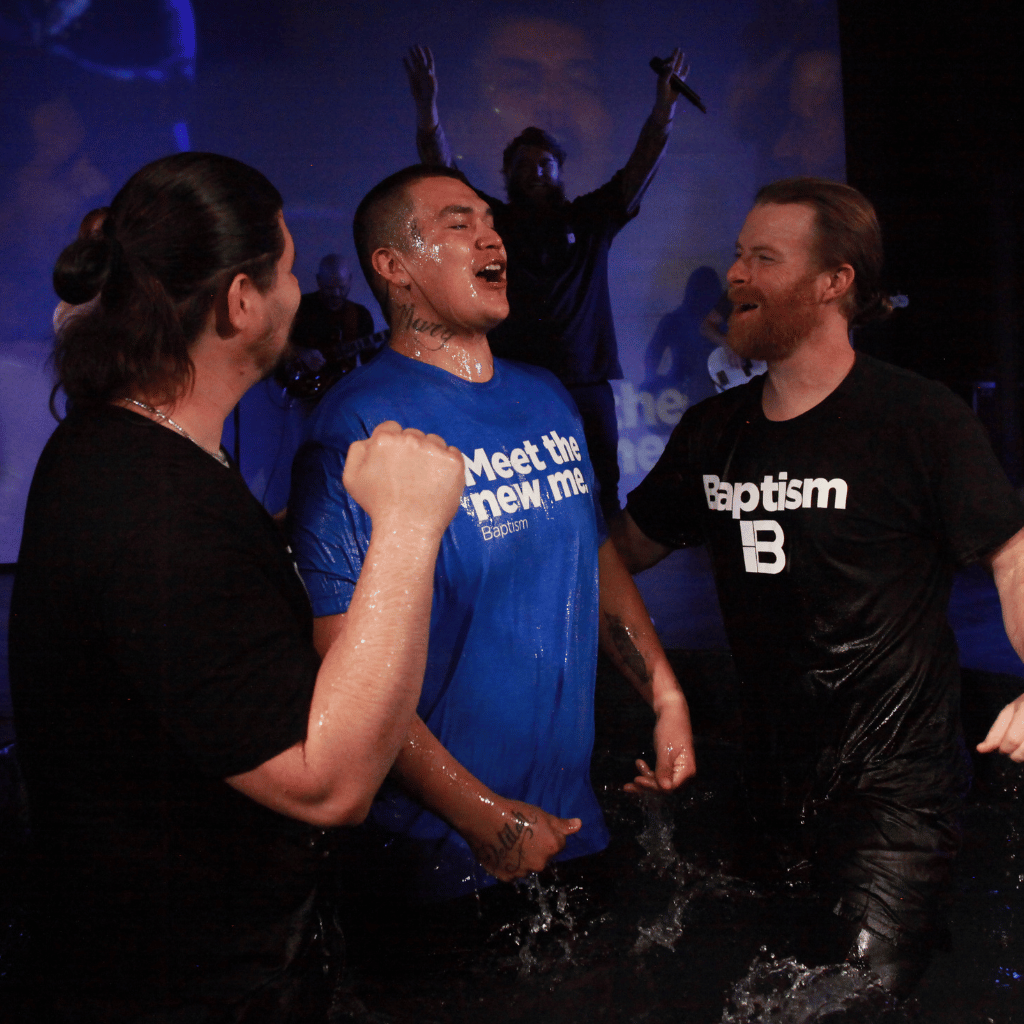 two guys baptizing man